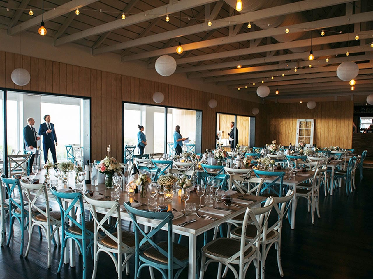 Tables Set Up For A Wedding With Lights And Lanterns at Coast Port Beach Oceanside Venue