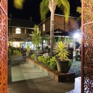 Garden Bar with Plants and Coco Tree and Dukes Inn's Building Behind