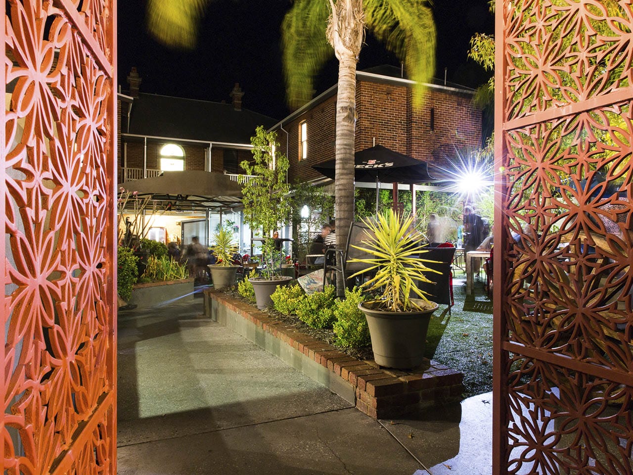 Garden Bar with Plants and Coco Tree and Dukes Inn's Building Behind