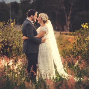 Wedding couple in field celebrating their marriage