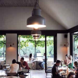 People Eating Inside the Restaurant With Hanging Lights.