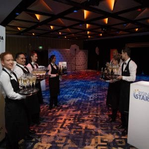 Wait Staff Waiting At The Entrance To The Function Room With Drinks For The Guests