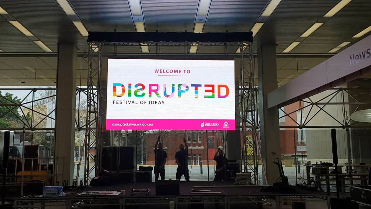 2 Men Hanging The Screen TV With Disrupted Event Sign