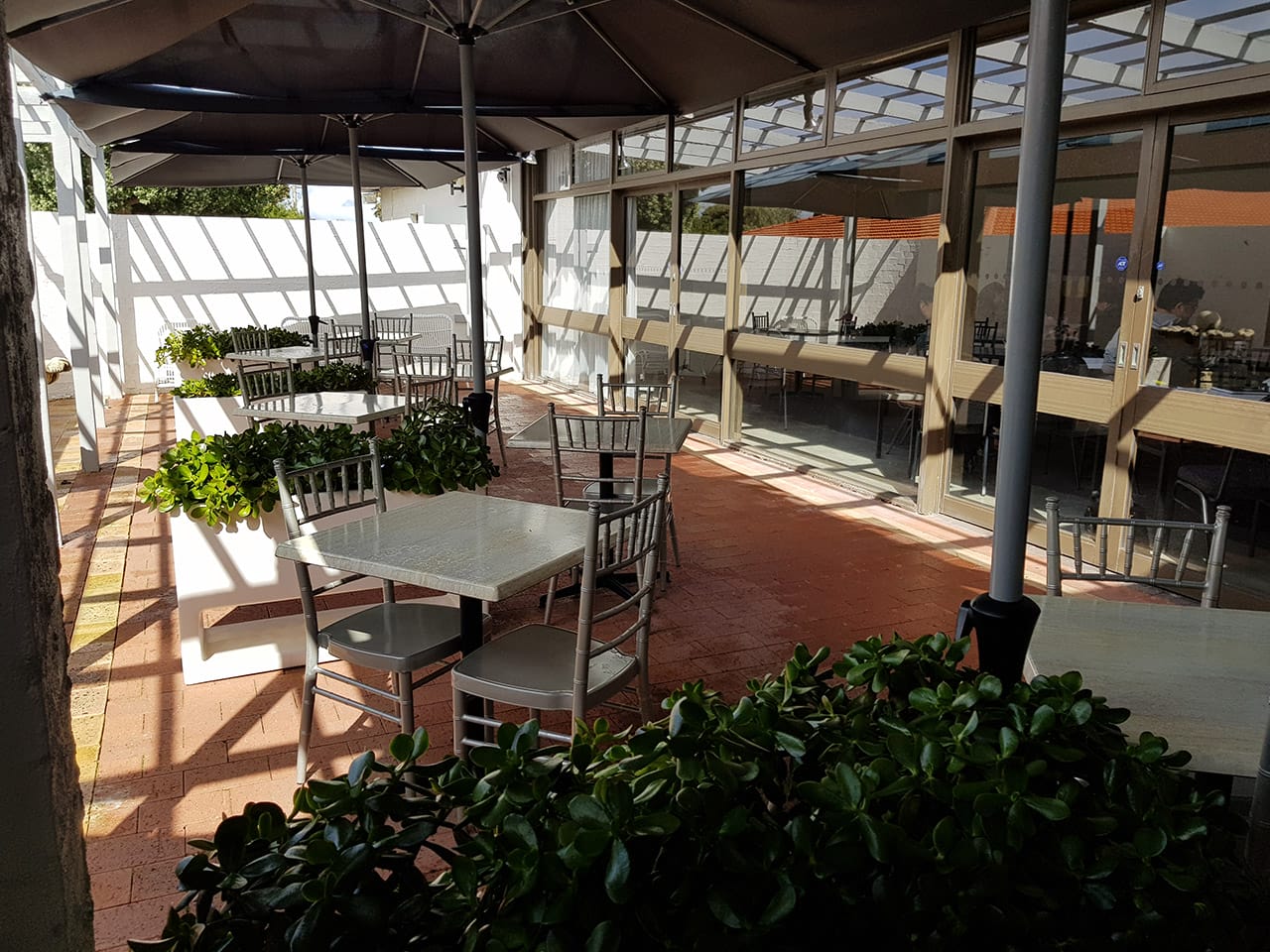 Chairs And Tables In The Alfresco With Green Plants