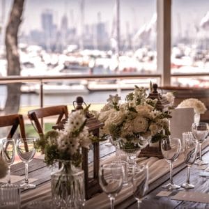 Long Dining Table Wedding Setup With River View And Flower Centerpieces