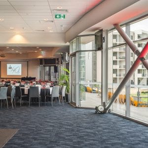 Inside The Function Room With Chairs And Tables In Banquet Style, Projection Screen And Outside View On The Right Side