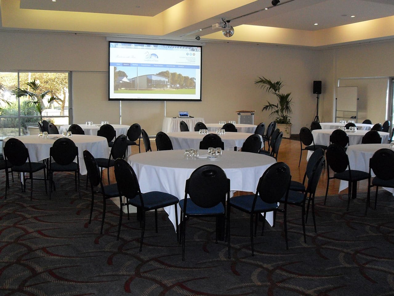 Banquet Style Setup With Projection Screen Inside The Function Room