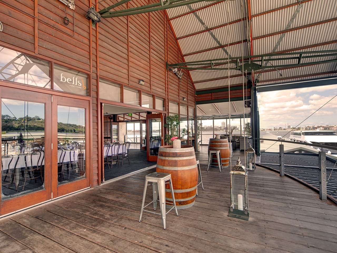 Perth Function Venue Balcony With Wine Casks As Table With Chairs And River Views