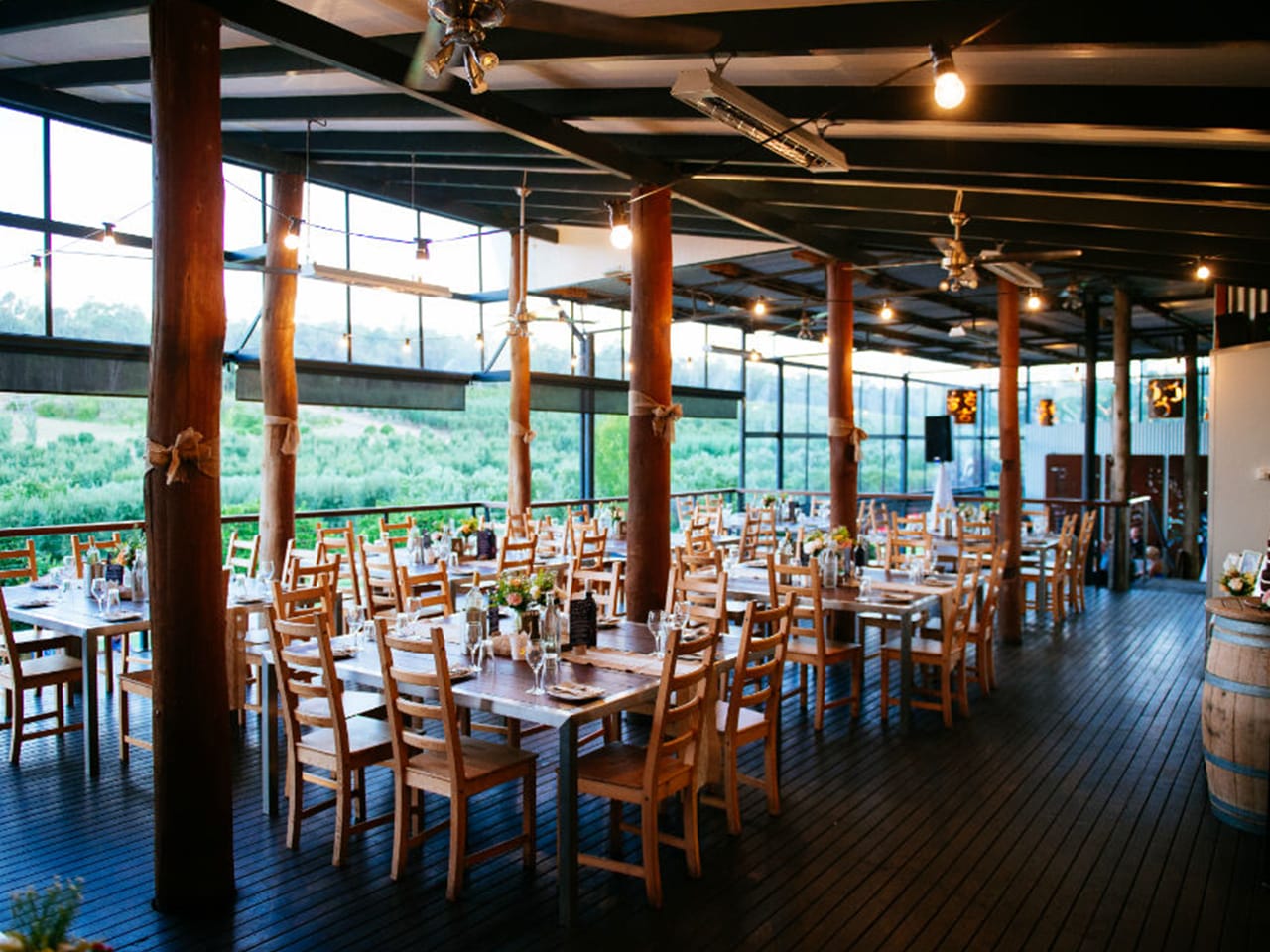 Chairs And Tables Inside The Function Room With Wine Cask On The Side, Hanging Lights And Perth Hills View