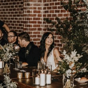 Bride at long table enjoying her special day