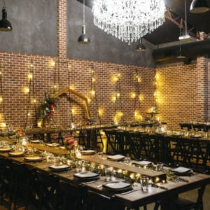 Full room setting with long tables and wall light decorations