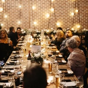 Guests at long tables enjoying a function