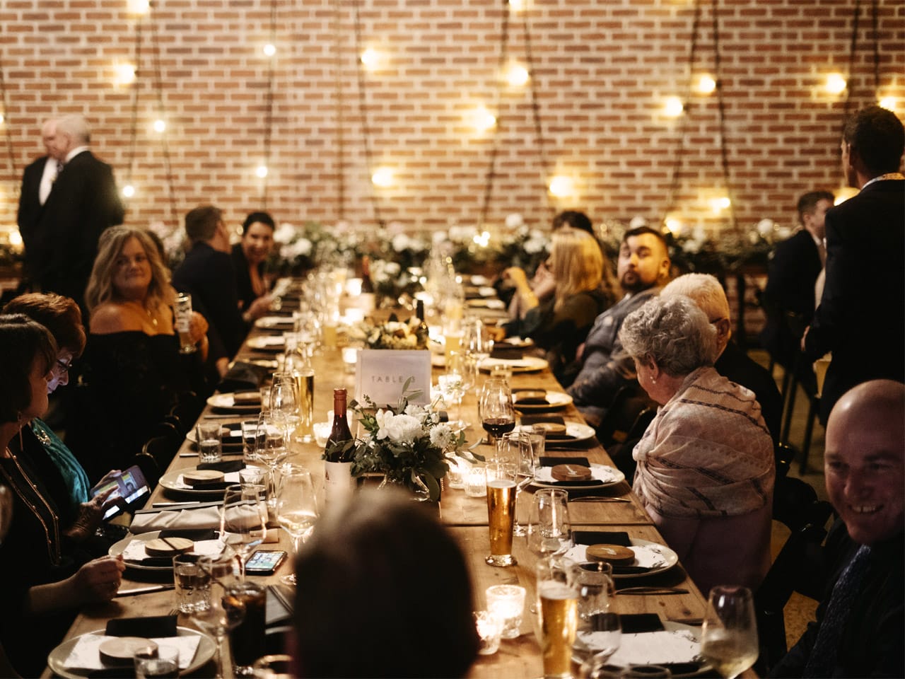 Guests at long tables enjoying a function