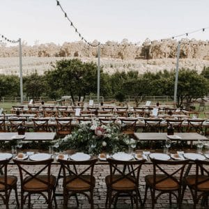 Empty long tables and seats set out for a wedding reception