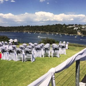 Outdoor seating for wedding with white seats overlooking river