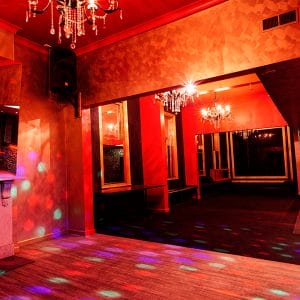 Empty Function Room With Chandelier And Red Lighting