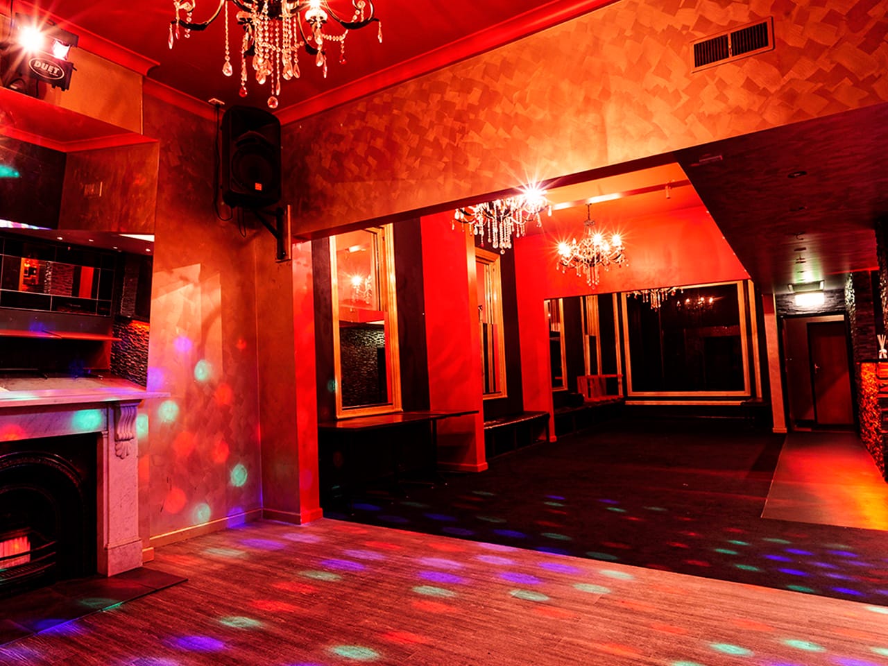 Empty Function Room With Chandelier And Red Lighting
