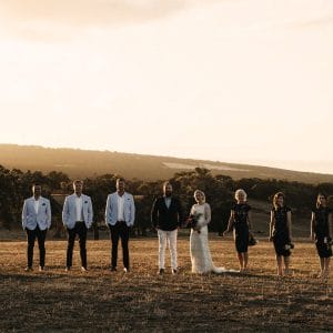 Bridal party at sunset on a hill