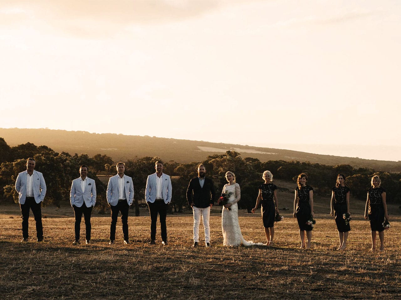 Bridal party at sunset on a hill