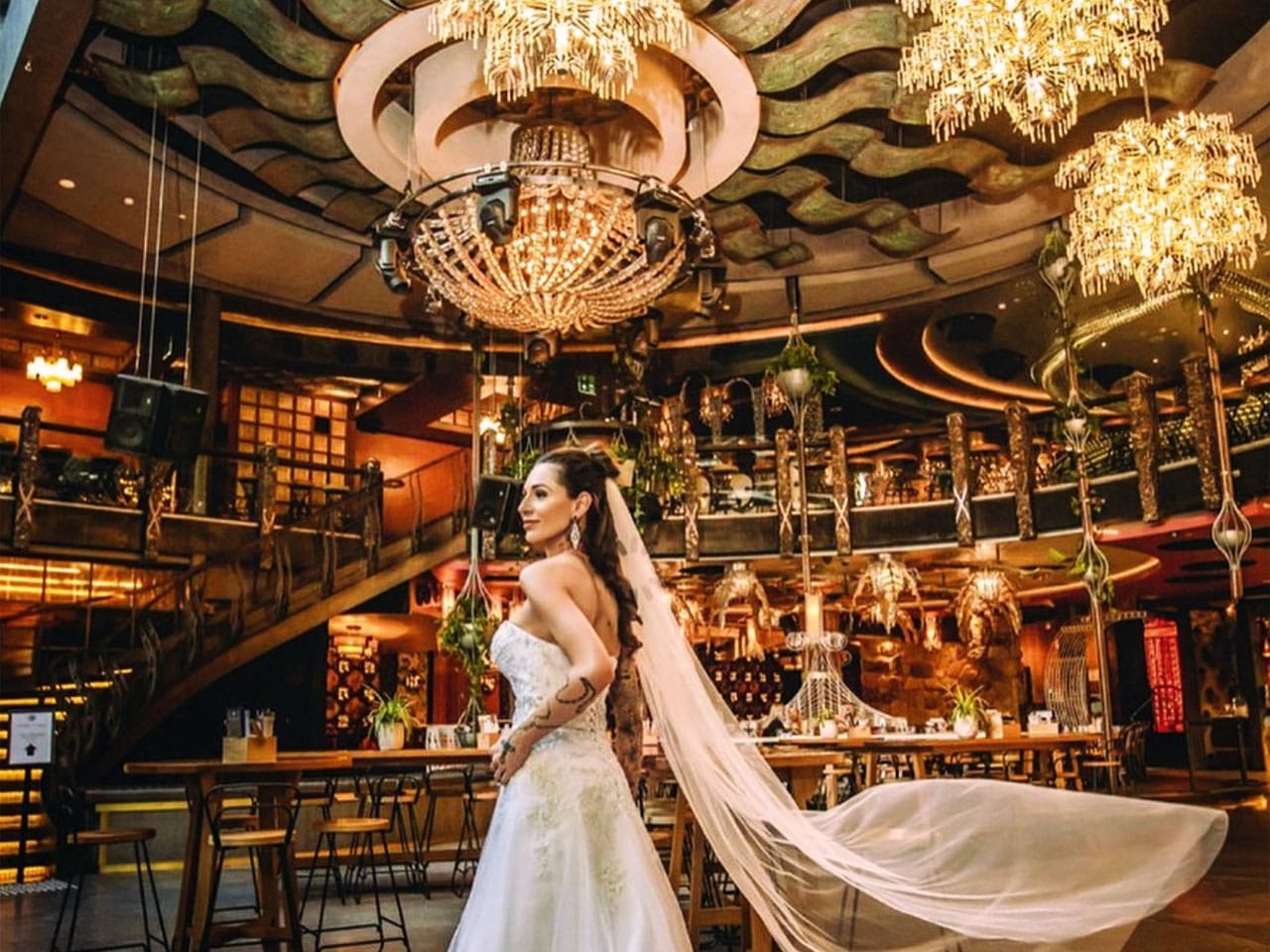 Bride walking through lavish dining area