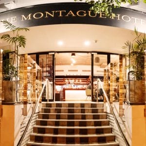 Montague Hotel entrance with sign above steps