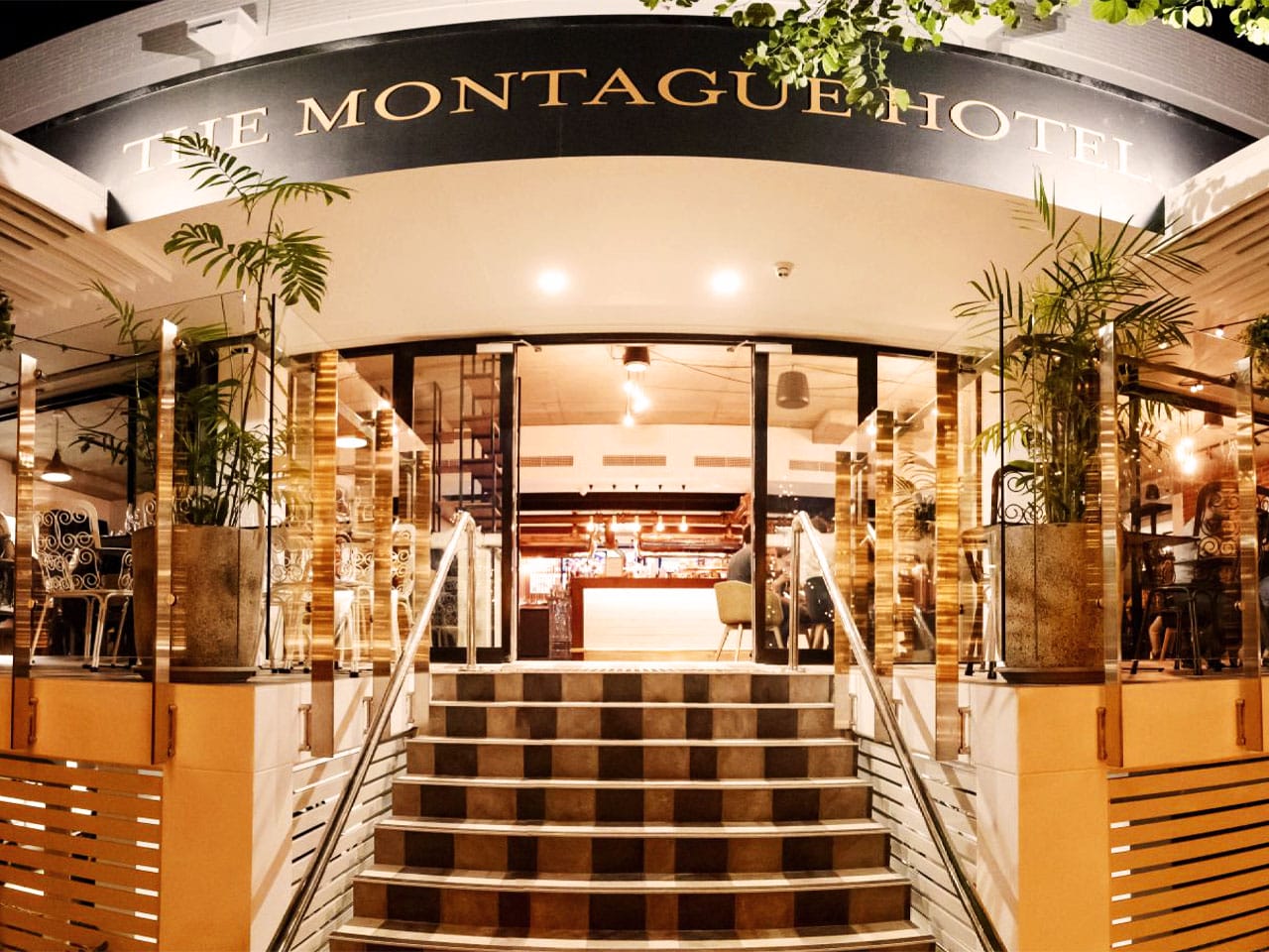 Montague Hotel entrance with sign above steps