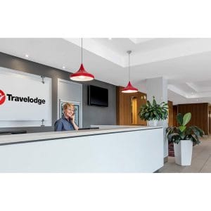 Travelodge reception area with lady on phone
