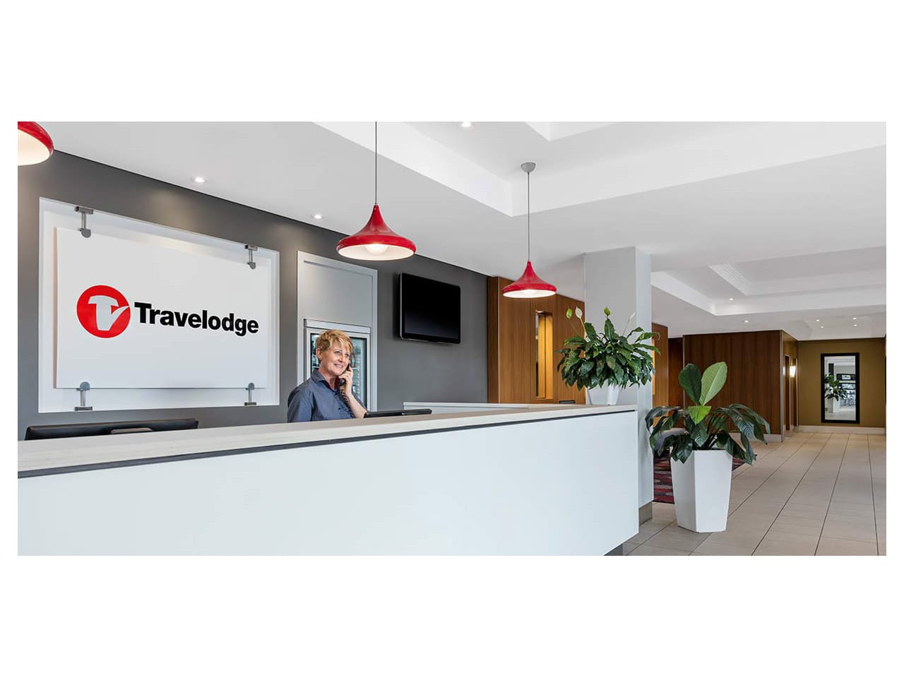 Travelodge reception area with lady on phone