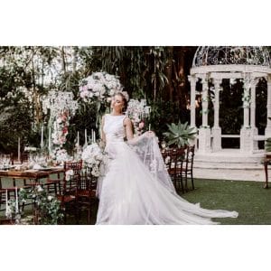 Bride enjoying wedding setting with white gazebo in background
