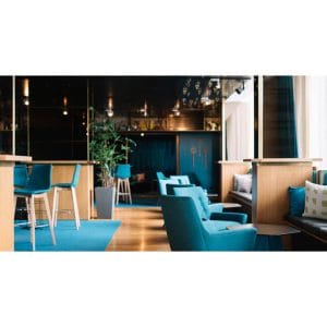 Function room with stylish blue and wood decor with matching blue chairs and wooden floor