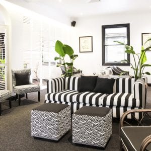 Black and white striped lounger with foot rest in bar area