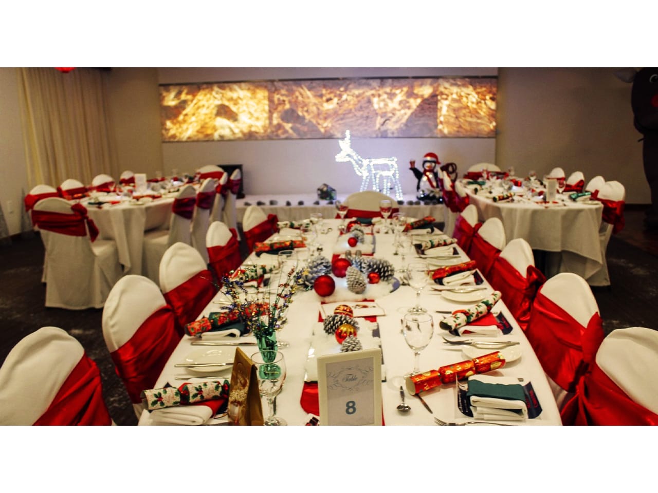 Red and white chairs at long white tables